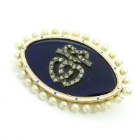 Lot 348 - Gold oval brooch with blue enamel, dressed