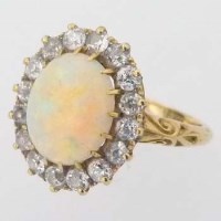 Lot 354 - 18ct gold cabochon opal and diamond oval cluster