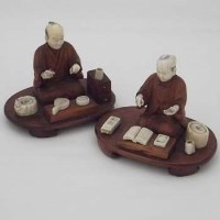 Lot 116 - Two carved hardwood and ivory figures.