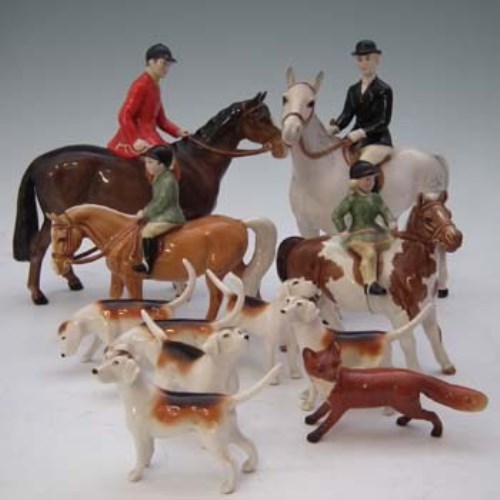 Lot 187 - Beswick hunt set including huntsman, huntswoman, girl on pony, boy on pony, six hounds and a fox.
