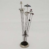 Lot 222 - Collection of nine hat pins and a Silver hat pin