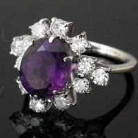 Lot 268 - 18ct gold amethyst and diamond oval cluster ring.
