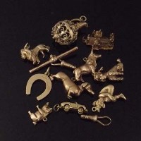 Lot 281 - Ten 9ct gold charms and two clips.
