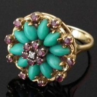 Lot 282 - Turquoise and ruby floret yellow gold ring.