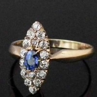 Lot 305 - Navette shaped sapphire and diamond cluster ring.
