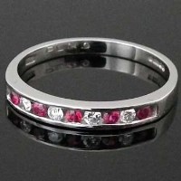 Lot 322 - Diamond and ruby eternity ring.