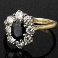 Lot 324 - 18ct gold sapphire and diamond oval cluster ring.