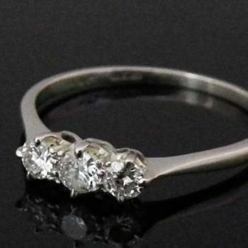 Lot 329 - Three-stone diamond platinum ring.