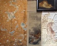 Lot 138 - Three Chinese embroidered and painted panels and a framed silkwork picture of lions (4)