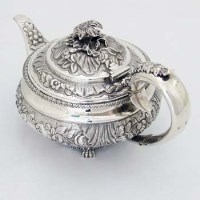 Lot 380 - George IV silver embossed teapot