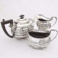 Lot 419 - George III style silver three-piece tea set