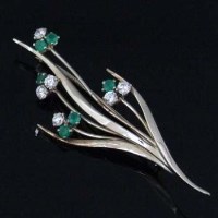 Lot 461 - 18K white gold emerald and diamond spray brooch