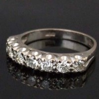 Lot 466 - 18ct white gold  seven-stone half hoop ring.