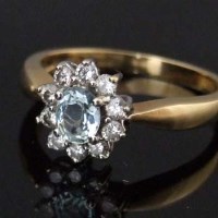 Lot 492 - Aquamarine and dianond oval cluster ring in 18ct