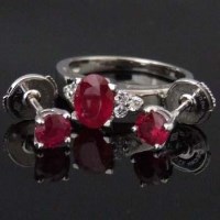Lot 518 - French 18ct white gold oval ruby ring, on diamond
