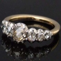 Lot 522 - Seven stone rose-cut diamond ring in yellow gold.