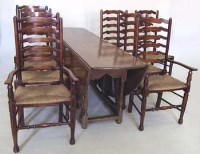 Lot 842 - Oak Wakes table and eight ladder-back chairs (2 carvers).
