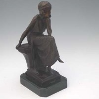 Lot 32 - Bronze figure of seated woman.
