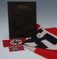 Lot 69 - Cast iron plaque depicting Adolf Hitler together with Nazi arm band, flag and patch (4).