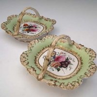 Lot 103 - Early 19th Century Coalport good pair of baskets with over handles painted with flowers.