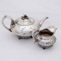 Lot 244 - Silver tea pot and milk jug.