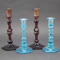 Lot 147 - Two pairs of coloured glass candlesticks.