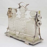 Lot 348 - Plated three-bottle tantalus.