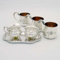 Lot 360 - Three .800 silver gilt cups; .835 cream, sugar and stand.