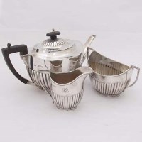 Lot 373 - Silver three piece tea set.
