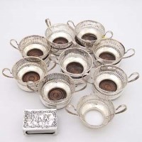 Lot 385 - Nine silver cup holders, eight silver coasters and a silver match box holder.