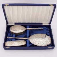 Lot 396 - Cased silver dressing table set.