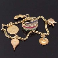 Lot 417 - Set of five gem-set rings; yellow metal charm