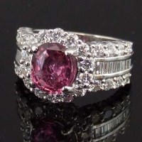 Lot 424 - Natural pink sapphire and diamond cluster ring