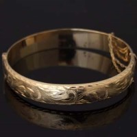 Lot 503 - 9ct gold hinged bangle.