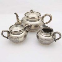 Lot 97 - Chinese white metal three piece tea set.