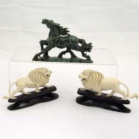 Lot 113 - Pair of ivory lions and a green soapstone Chinese horse