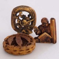 Lot 95 - Netsuke and two carved roundels (3).