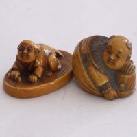 Lot 97 - Two netsukes of crouching figures.