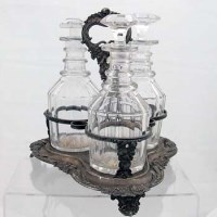 Lot 188 - Sheffield plate three-bottle decanter stand and bottles.