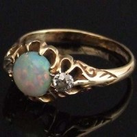 Lot 284 - Edwardian opal and diamond three-stone ring