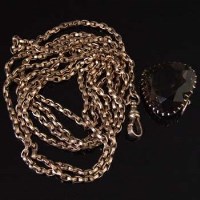 Lot 291 - 9ct gold muff chain with smokey pendant.