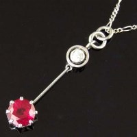 Lot 292 - Ruby and diamond barbell shaped pendant, 28mm, on