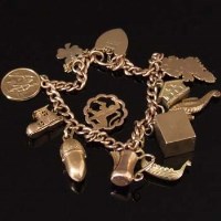 Lot 311 - 9ct gold charm bracelet.