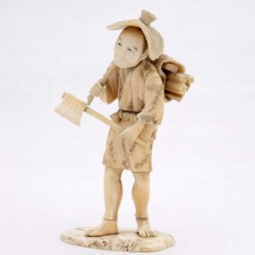 Lot 96 - Ivory figure of a man with bundle of sticks.