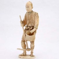 Lot 97 - Ivory figure, man with basket and pick.