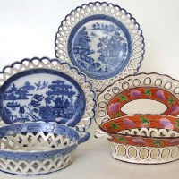 Lot 156 - Creamware pierced basket and stand a pearlware basket and stand and one other plate