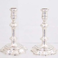 Lot 250 - Pair of cast silver Geo II style candlesticks
