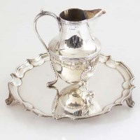 Lot 302 - Silver cream jug and a waiter.