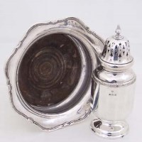 Lot 328 - Silver bottle coaster and a silver caster (2).