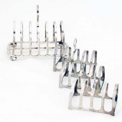 Lot 334 - Silver toast rack and three small toast